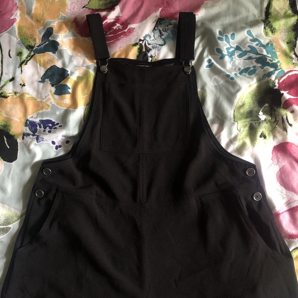 Black cropped overalls.